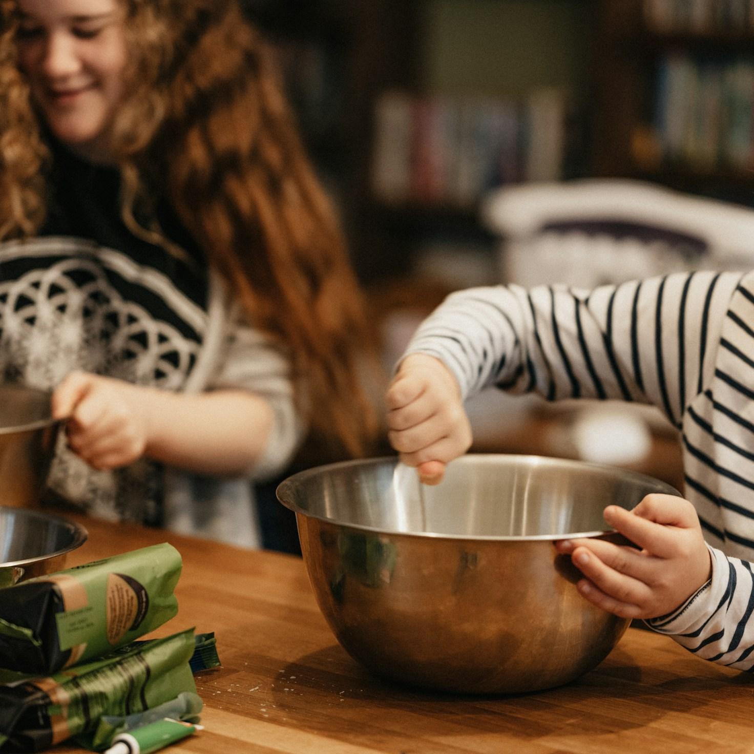 Community members collaborating in a contemporary kitchen space, sharing recipes and cooking techniques